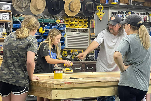 Girls with Paw Paw working on Ladders